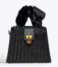 MME.Mink Winter Monaco Petite Fur Bag in Noir Our most popular wicker bag is back for Fall/Winter 2022 dressed up! Our Monaco Bag is this season's fanfare piece, inspired by Grace Kelly's glamorous lifestyle on the Riviera. This bag's clam-shell opening securely closes with a snap feature and the simple interior is a lightweight organic twill with a slip pocket. SIZE: 10"W x 11"H x 5"D Material: Organic Woven Wicker Tote with twill lined interior. Luxury Woven Straw Bag With Top Handle, Luxury Woven Top Handle Straw Bag, Luxury Evening Straw Shoulder Bag, Luxury Evening Straw Tote Bag, Chic Rectangular Straw Bag For Formal Occasions, Luxury Basket Bag With Bamboo Handle, Luxury Straw Top Handle Bag, Designer Straw Bag With Braided Handles For Evening, Luxury Black Woven Straw Bag