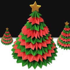 three origami christmas trees with gold stars on top and one red tree in the middle