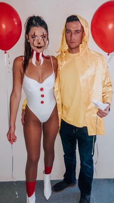 a man and woman dressed in costumes standing next to each other with balloons behind them