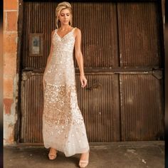 a woman standing in front of a garage door wearing a dress with sequins