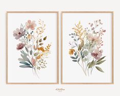 two framed art prints with flowers and leaves on white paper, one in gold and the other in pink