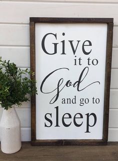 a sign that says give it to god and go to sleep next to a potted plant