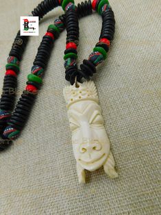 The African pendant is a beautiful bone carved piece. The hand carved African pendant is approximately 3 inches long with great detail. It is a thick piece. The necklace is beaded with a mix of African hand painted glass and wooden beads. The necklace closes with a large toggle clasp for easy access. If you have any questions please feel free to contact us at anytime. The piece will ship with insurance. Our products are not intended for babies or children as we use small pieces, wires and beads. These can be dangerous to them when unsupervised. Gift boxes and gift messages are available for your special orders. If you need the sizes in cm,mm or in other sizes we will provide that information. Contact us at blackertheberry@ sbcglobal.net for any questions. Please feel free to leave a review Unique Carved Beaded Necklaces As Gift, Unique Carved White Necklace, Unique White Carved Necklace, Traditional Carved Adjustable Beaded Necklaces, Traditional Adjustable Carved Beaded Necklaces, Traditional Adjustable Carved Beaded Necklace, Artisan Carved White Necklace, Traditional White Carved Necklaces, White Carved Amulet Necklace