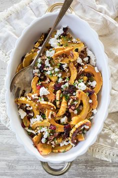 a white bowl filled with fruit and nuts