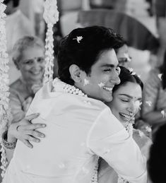 the bride and groom are hugging each other