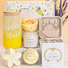 the bride's maid gift set includes a candle, keychain, and ring box