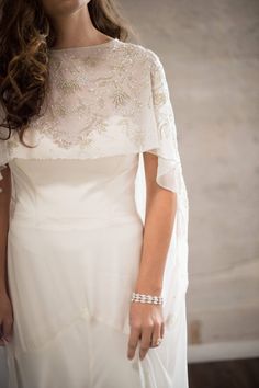 a woman with long hair wearing a white dress