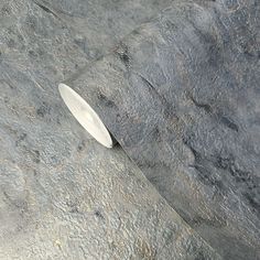 a white object sitting on top of a stone floor