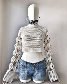 a mannequin wearing shorts and a top with crochet on the sleeves