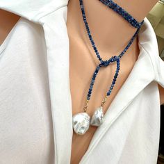 Simple and beautiful single strand of blue Kyanite faceted beads adorned with 2 large white baroque pearls which serve as focal points and add a touch of elegance. Baroque pearls are known for their irregular shapes, giving them a unique and organic appearance. The white pearls provide a subtle contrast against the denim blue Kyanite, creating a harmonious balance. The necklace measures 48" inches in length, allowing for versatile styling options. Its longer length allows it to be wrapped around Pearl Necklace Outfit, Beaded Lariat Necklace, Necklace Outfit, Irregular Shapes, Focal Points, Blue Kyanite, Personalized Gifts For Her, September Birthstone, Lariat Necklace