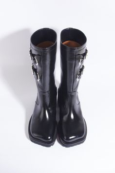 Women's biker boots. It's More Bike Boots in Black with a contemporary design, incorporating chunky heels and a stylish metal ornament attached to the side upper ***Please ensure that we follow the Italian shoe size. Here is the link on how to choose your shoe size. https://jelaconnais.com/pages/how-to-select-the-right-shoe-size-for-you Details: * Composition - Upper: Cow Leather - Lining: Pigskin, kip - Sole: Leather, Rubber *Heel Height: 40mm *Color: Black Womens Biker Boots, Bike Boots, Italian Shoes, Biker Boots, Pig Skin, Metal Ornament, Designer Boots, Rubber Heels, Chunky Heels