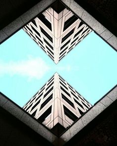 looking up at the top of two tall buildings