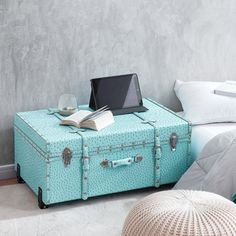 an open suitcase sitting on top of a bed next to a laptop computer and pillow