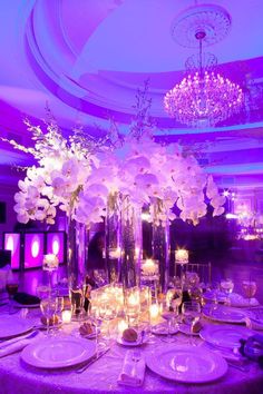 the centerpieces are filled with flowers, candles and place settings for an elegant dinner