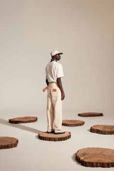 a man standing on top of wooden slices