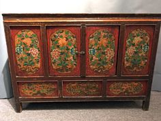 an old wooden cabinet with floral designs on it