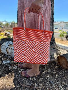 "This beautiful hand-woven, small tote is the latest creation of my business parter Cupertino. Handcrafted in Mexico. 9 1/2\"L x 9 1/2\"H x 5\"D; 16\" H with straps." White Woven Basket Shoulder Bag, White Handwoven Basket Shoulder Bag, White Handwoven Rectangular Shoulder Bag, Handmade White Basket Shoulder Bag, White Handwoven Shoulder Bag For Market, White Handwoven Square Shoulder Bag, Casual Orange Woven Shoulder Bag, Orange Woven Rectangular Shoulder Bag, Summer Handwoven Orange Shoulder Bag