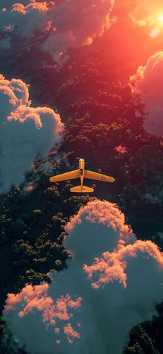 an airplane is flying in the sky above some clouds and trees, as the sun sets