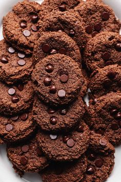 a white plate filled with chocolate cookies on top of a table