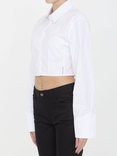 Cropped structured shirt in white organic cotton with boning that runs from the waist to the bust for a sculpting effect. It features classic collar, front button closure and buttoned cuffs. Logo label at the side seam. Fitted cut. The model is 175cm tall and wears size US 6.Size nationality: US Product number: 8316821 Product code: 1WC2241880100 Composition: 100% cotton Classic White Cropped Shirt For Daywear, White Cropped Shirt With Long Sleeves And Buttons, White Cropped Long Sleeve Shirt With Buttons, Fitted Cropped Blouse With Button Cuffs, Fitted Cropped Long Sleeve Shirt For Daywear, Fitted White Cropped Shirt With Buttons, Classic Cropped Shirt For Daywear, Fitted Cotton Cropped Shirt For Work, Fitted Collared Cropped Shirt For Daywear