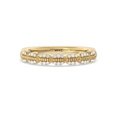 a gold and white diamond ring with rows of diamonds on the band, set in 18k yellow gold