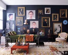 a living room filled with lots of pictures on the wall and furniture in front of it