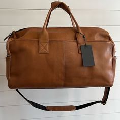 Shop artofalpine's closet or find the perfect look from millions of stylists. Fast shipping and buyer protection. Danish leather men’s travel bag. Structured leather color cognac with crossbody strap and side exterior pockets Rolling Briefcase, Travelon Bags, Bike Saddle Bags, Large Duffle Bag, Tumi Luggage, Golf Stand Bags, Weekend Travel Bags, Leather Travel Bag, Duffel Bag Travel