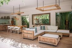 a living room filled with furniture and lots of windows