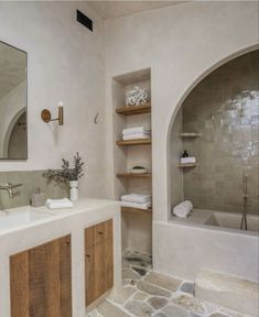 a bathroom with stone floors and white walls