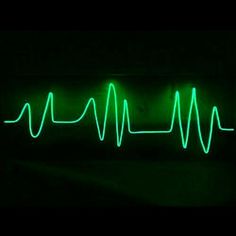 a neon green heartbeat is shown in the dark