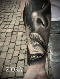 a person with a black and white tattoo on their arm