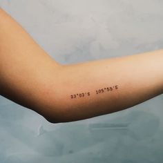 a woman's arm with the date tattooed on it