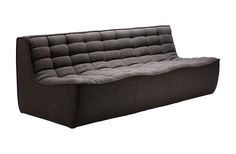 a black and grey couch sitting on top of a white floor