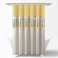 a shower curtain with yellow and silver stripes on the bottom, in front of a white bathtub