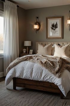 a bedroom with a large bed and two pictures on the wall