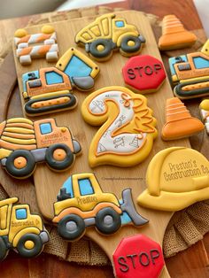 decorated cookies with construction vehicles on a wooden platter for two year old birthday party