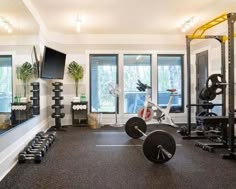 a gym with exercise equipment and mirrors