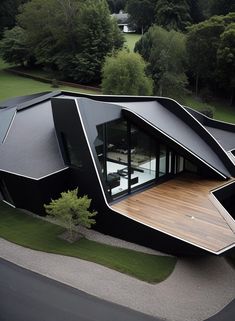 an aerial view of a modern house in the middle of a park with trees and grass