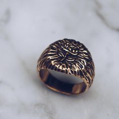 Antiqued gold brass ring with a floral rose engraving. This women's or men's gold brass ring has a beautiful signet style. The rose has ancient symbolic meaning including love, beauty and timelessness. Available in Sterling Silver: https://etsy.me/2RAJ6vD Ring Size Available in all sizes. Please be sure to find your exact ring size for the finger you want before ordering. See image chart above or you can use the chart on my website as a guide - https://jewelrylab.co/pages/ring-sizing-tips A note Gold Copper Round Ring, Rose Gold Brass Wedding Ring, Vintage Gold Engraved Skull Ring, Gold Copper Promise Ring, Anniversary Rose Gold Brass Rings, Rose Gold Flower Ring As A Gift, Rose Gold Open Ring In Brass, Gold Etched Brass Rings, Adjustable Symbolic Rose Gold Rings