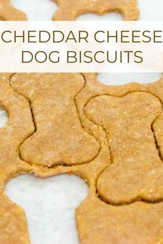 a close up of dog biscuits on a table with the words cheddar cheese dog biscuits