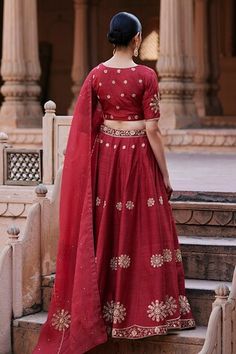 Vermillion red flared raw silk lehenga with edelweiss bloom motif zardozi embroidery. Paired with a half sleeves pure silk sweetheart neck blouse with floral motif buta zardozi embroidery and organza dupatta adorned with spluttered zardozi accents. - Aza Fashions Chanderi Dress With Motifs For Wedding, Chanderi Wedding Dress With Motifs, Designer Red Dresses With Motifs, Elegant Red Sets With Motifs, Wedding Raw Silk Sets With Motifs, Raw Silk Wedding Sets With Motifs, Wedding Sets In Raw Silk With Motifs, Wedding Sets With Motifs In Raw Silk, Red Chanderi Wedding Set