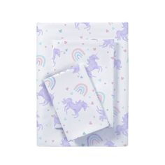 two sheets with unicorns on them and hearts in the background, one sheet has a rainbow