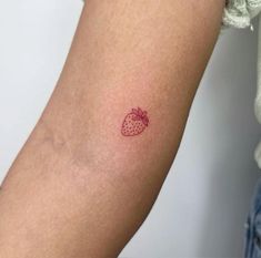 a small strawberry tattoo on the left arm and right arm is red, but it's not white