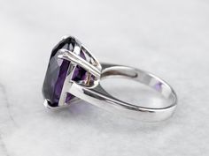 This exceptional amethyst commands attention! Generous in size, this gemstone sparkles with juicy hues of violet, fuchsia, and royal purple. A simple setting of 18 karat white gold lets the amethyst be the star of the show. Metal: 18K White Gold Gem: Amethyst 12.20 Carats Gem Measurements: 12.9 x 16.9 mm, Oval Ring Size: 6.25 Marks: "750" Stamped on the inside band Formal Amethyst Jewelry With Polished Finish, Elegant Purple Jewelry With Polished Finish, Formal Purple Amethyst Solitaire Ring, Formal Purple Solitaire Amethyst Ring, Formal Purple Diamond Cut Jewelry, Formal Purple Jewelry With Polished Finish, Elegant Purple Platinum Jewelry, Timeless Purple Jewelry For Formal Occasions, Classic Purple Amethyst Ring With Polished Finish