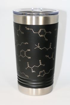 a black and silver cup with some chemical symbols on it