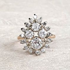 "Antique Diamond Cluster Ring 14K Yellow and White Gold Art Deco 1.59 CTW Old European & Round Brilliant! GIA G.G. Appraisal Incl 6,260 Usd! This amaaaazing ring will be cherised by the vintage loving woman who likes to make a statement! The crown is large and measures approximately mm x mm, forming a pear shaped cluster, and rises mm from the finger. It has a WOW presence on the hand, beautiful without being gaudy. The largest diamond is .60 carat, SI1 clarity and G color and is an old european Luxury Rose Cut Diamonds Cluster Wedding Ring, Dazzling White 14k Gold Cluster Ring, Dazzling White Gold Cluster Ring With Rose Cut Diamonds, Dazzling Yellow Gold Cluster Ring With Rose Cut Diamonds, White Marquise Diamond Ring With 17 Jewels, Marquise Diamond Ring With 17 Jewels, Fine Jewelry Platinum Cluster Ring With 17 Jewels, Timeless Platinum Cluster Ring In Yellow Gold, Timeless Yellow Gold Cluster Ring In Platinum