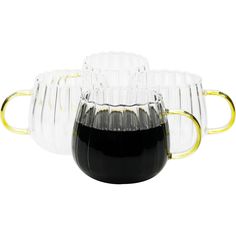 three glass mugs with gold handles are sitting next to each other on a white surface