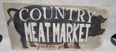 a sign that says country meat market with a pig on it's back side