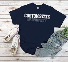 "Custom University Shirt, Varsity Outlined University Tshirt Unisex for Mens and Women available in 10 color ; Black, White Navy, Sport Grey, Royal Blue, Irish Green, Red, Natural, Military Green, Dark Chocolate. This shirt using USA standard size; S, M, L, XL, 2XL, 3XL, 4XL. Tee Spec's Using Direct to Garment (DtG) for quality and durability print. Using semi-fitted tee full cotton for cool & comfort t-shirt. * 100% ring-spun cotton * Pre-shrunk for extra durability * Shoulder-to-shoulder taping * Quarter-turned to avoid crease down the center. Size Chart S 18\" with 28\" length M 20\" with 29\" length L 22\" with 30\" length XL 24\" with 31\" length 2XL 26\" with 32\" length 3XL 28\" with 33\" length 4XL 30\" with 34\" length 5XL 32\" with 35\" length Handling time After clearing payment Education Shirts, College Tees, University Shirt, University Tshirt, Personalized Gifts For Mom, Fitted Tee, Green Dark, Military Green, Favorite Shirts