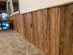 a wood paneled wall in an empty room